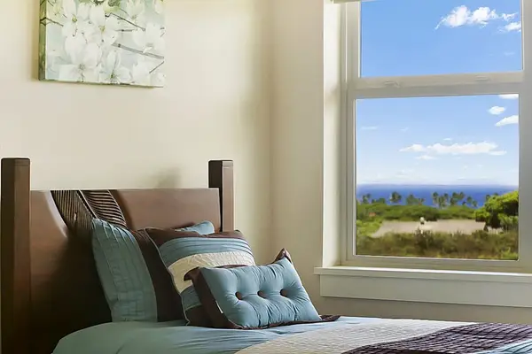 Guest room with two twin beds and flat screen TV.