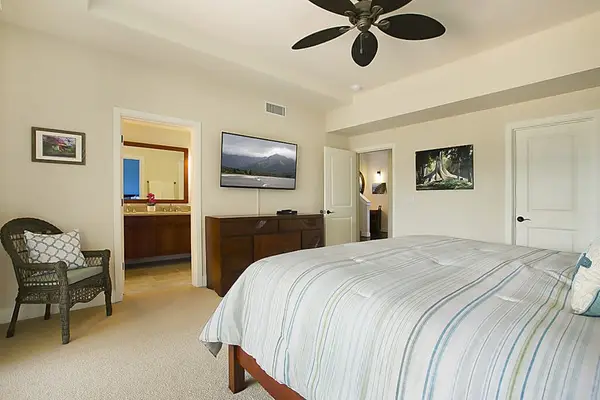 Calming main bedroom with a king bed, private lanai, flat screen tv and en suite bathroom.