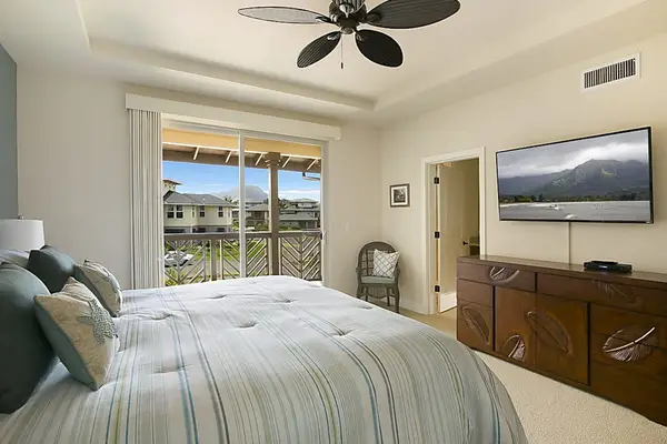 calming main bedroom with a king bed, private lanai, flat screen tv and en suite bathroom.