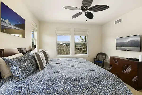 Guest room with king bed with flat screen tv.