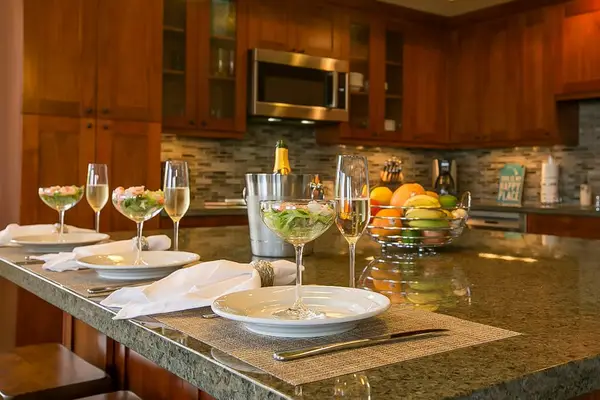 High-end and high-style, the open kitchen boasts handsome cherry cabinets, granite counters, stainless appliances, and a large island with seating for three.