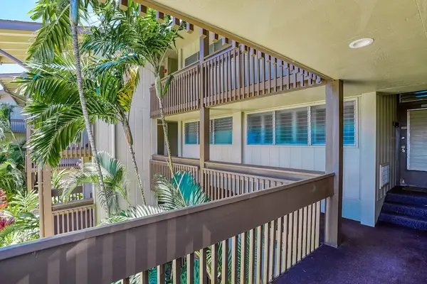 Open-air walkway surrounded by tropical landscaping
