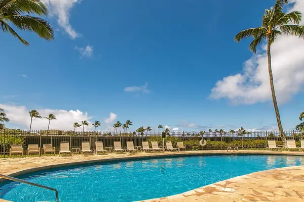 Relax poolside surrounded by tropical landscaping