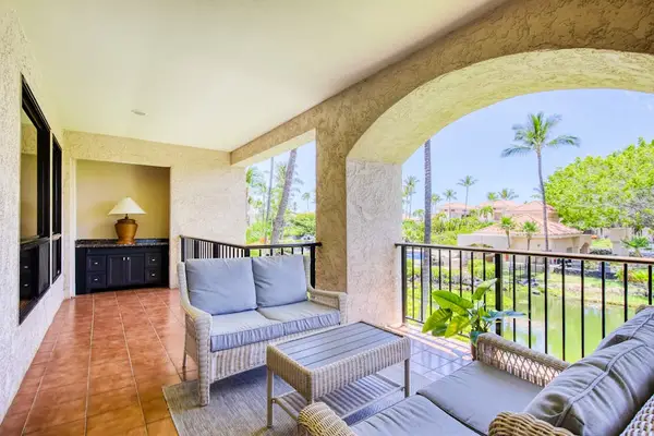 Covered balcony offers relaxing seating for peaceful morning coffee outdoors