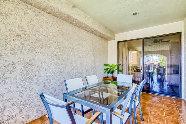 Al fresco dining area offers comfortable seating beneath covered lanai