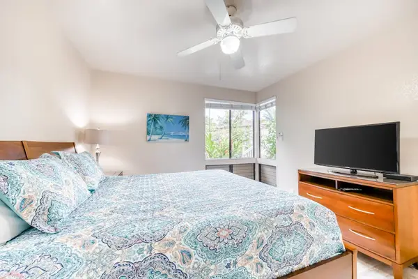 Airy bedroom with comfortable bedding and plenty of natural light