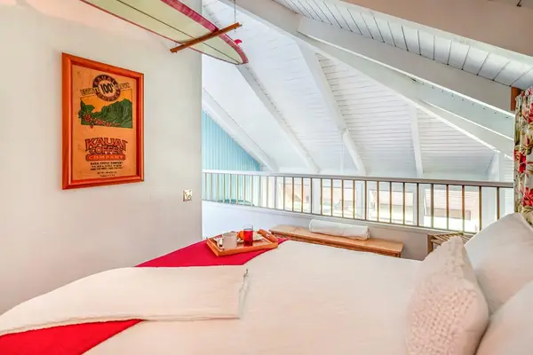 Relax in the cozy guest bedroom with vaulted wood ceilings.
