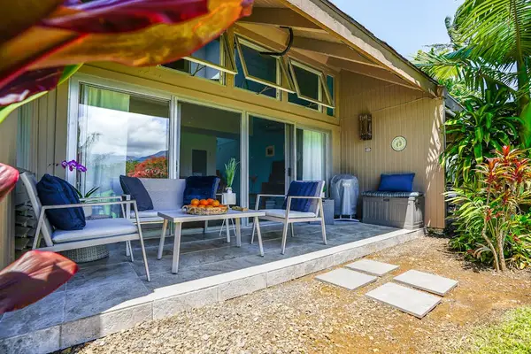 Spacious covered lanai with outdoor seating for relaxing and dining.