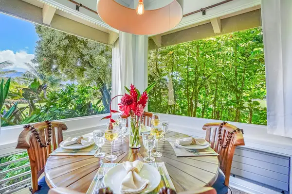 Enjoy outdoor dining on the covered lanai overlooking the tropical gardens.