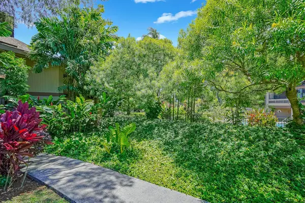 Enjoy the spacious lawn surrounded by tropical gardens.