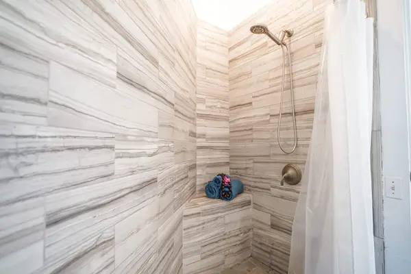 Walk-in shower with elegant tile finishes.
