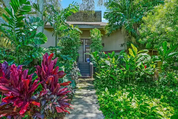 Lush tropical gardens create a peaceful island setting.