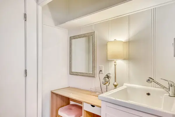 Bedroom vanity offers generous counter space and a large mirror