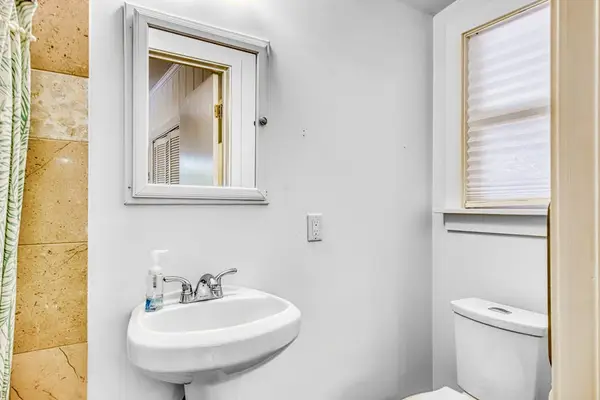 Master bathroom shower and pedestal sink create a fresh, practical space