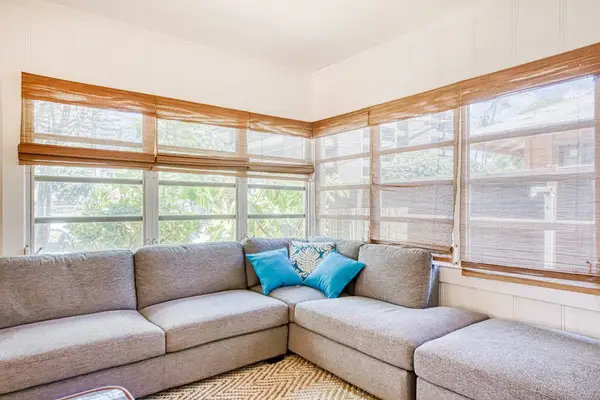 Relax beside wraparound windows in this cozy corner living space