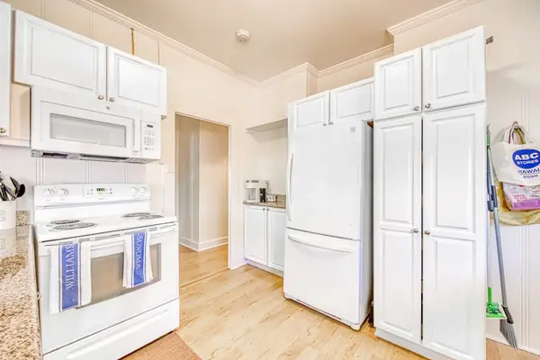 Open kitchen offers generous counters and easy dining room access