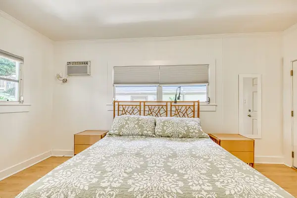 King bedroom with a spacious layout and softly filtered daylight