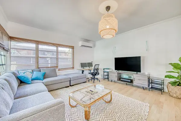 Unwind in the sunlit living room with plush sectional seating