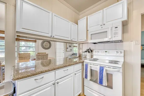 Well-equipped kitchen provides ample cabinetry and practical counter space