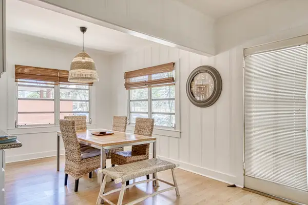 Gather around the window-side dining table beneath a woven pendant light