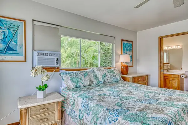 Plush Bed, Ensuite Bathroom Access, Window A/C, Ceiling Fan & Dual Nightstands