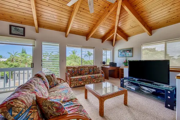 Cozy living room with vaulted ceilings and TV setup