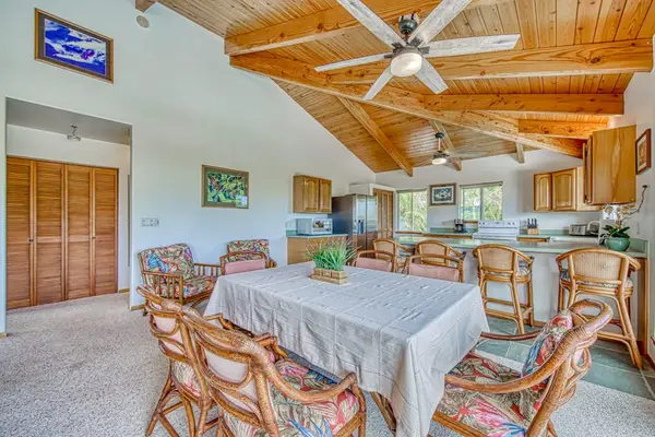 Cozy Dining Table, Island Bar Seating, Ceiling Fan & Open Kitchen Flow