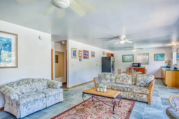 Multiple Sofas, Area Rug, Coffee Table, Dual Ceiling Fans & Open Layout