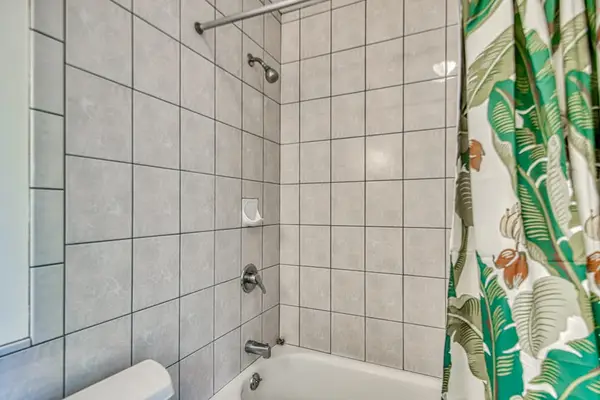 Full Bathtub and Shower Combination, Tiled Surround & Tropical Shower Curtain