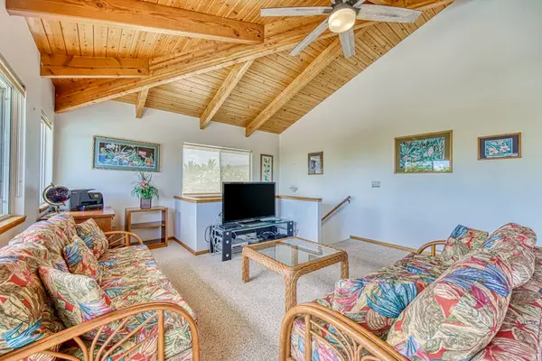 A full view of the seating layout, entertainment center, cooling amenities, and architectural features included in the main lounge space.