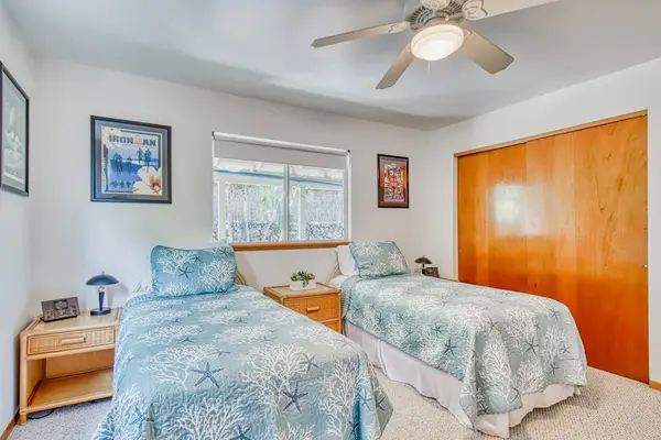 Two Beds, Large Closet Storage, Ceiling Fan Light, Bedside Tables & Artwork