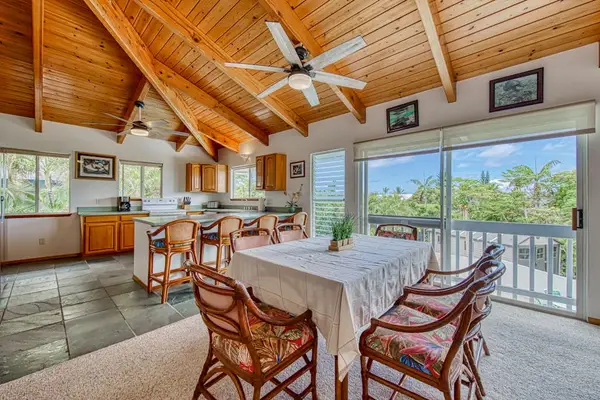 Spacious dining area with vaulted ceilings and balcony access