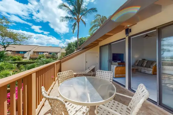 Balcony dining seating frames mountain vistas and vibrant tropical landscaping
