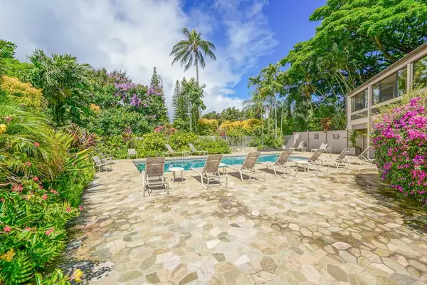 Spacious pool deck with lounge chairs for relaxing in the Hawaiian sunshine.