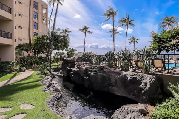 Picturesque Rock Waterfall Nestled In Tropical Resort Gardens