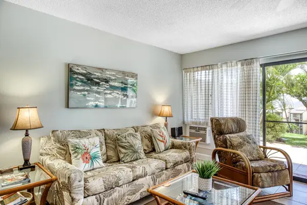 Open living room offers comfortable seating and natural garden views