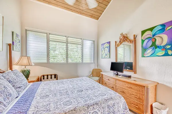 Bright primary bedroom with tropical décor