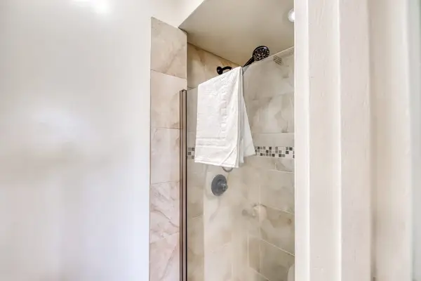 Walk-in shower with modern tile finishes