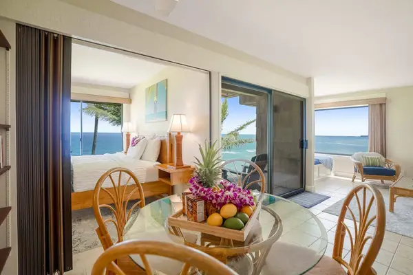 Open dining and lounge area framed by floor-to-ceiling ocean views