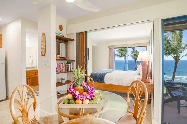Dining table with seating, leading into the main living spaces and bedroom