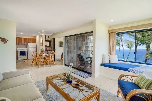 Open-concept living area with fully equipped kitchen and scenic window seat