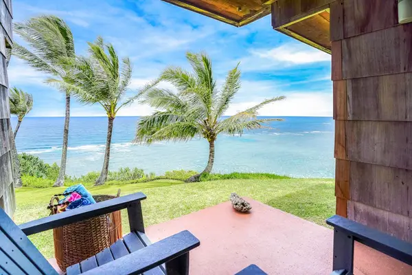 Private lanai overlooking tropical palms and the ocean