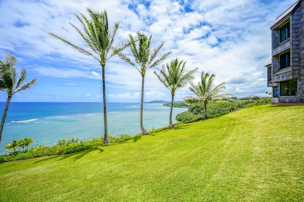 Expansive oceanfront lawn offering panoramic views of the coast and mountains
