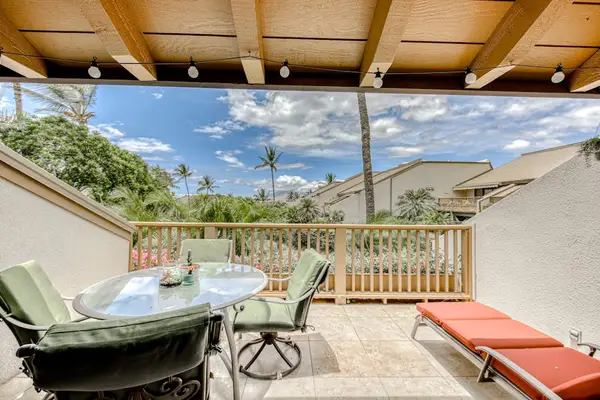 Covered lanai with outdoor dining and lounge seating