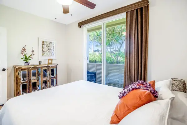 Master bedroom with king bed, flat screen tv, an en-suite bathroom and a private lanai over looking the gardens and the pool