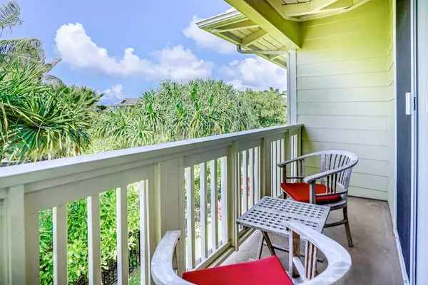 Private lanai surrounded by lush tropical paradise, vibrant flowers, and swaying palms—the perfect place to relax and soak in the island atmosphere.