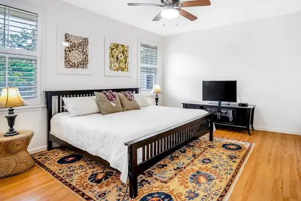 Master bedroom with king bed, flat screen tv, an en-suite bathroom and a private lanai over looking  the gardens and the pool