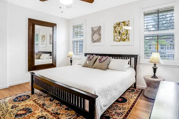 Master bedroom with king bed, flat screen tv, an en-suite bathroom and a private lanai over looking  the gardens and the pool