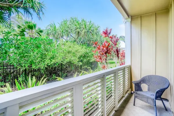 Private lanai surrounded by lush tropical paradise, vibrant flowers, and swaying palms—the perfect place to relax and soak in the island atmosphere.