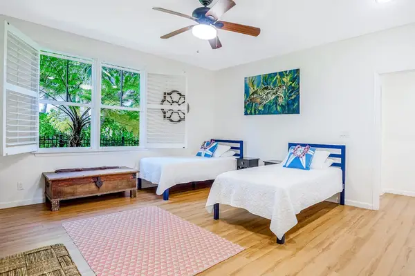 Extra living area with two single beds and a flat screen tv.